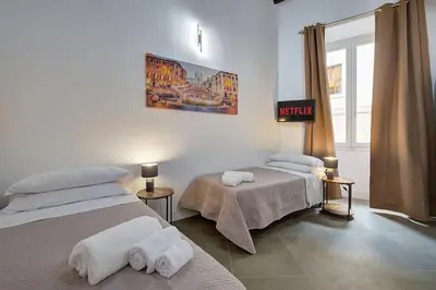 a bedroom with two beds and a sign that reads virgin at Domus Capitolina Pantheon in Rome