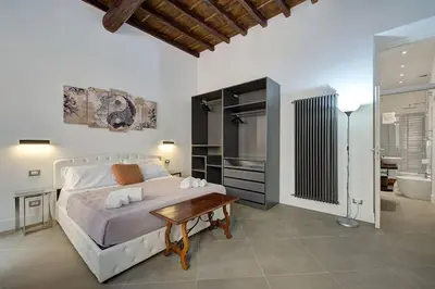 a bedroom with a large bed and a bathroom at Domus Capitolina Pantheon in Rome