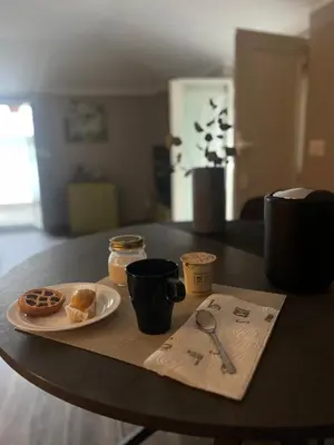 a table with a plate of donuts and coffee cups at Maison LuCe in Rome