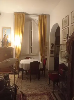 a dining room with a table and chairs in a room at Fiore73 in Rome
