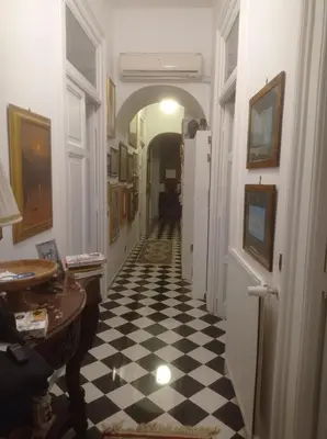 a hallway with a black and white checkered floor at Fiore73 in Rome