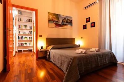a bedroom with a bed with two towels on it at Orange Nest in Rome