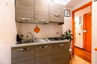 a kitchen with a sink and a stove at Orange Nest in Rome