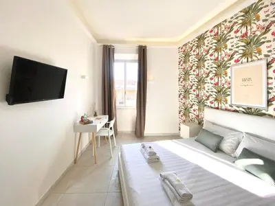 a bedroom with a bed and a tv on a wall at Prince of Rome Superior Rooms in Rome