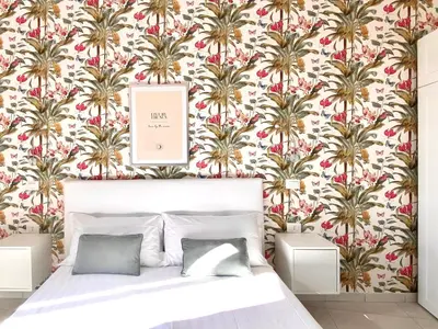 a bedroom with a floral wallpaper with a bed in it at Prince of Rome Superior Rooms in Rome
