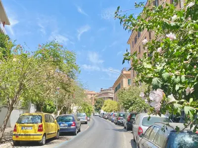 a street with cars parked on the side of the road at Prince of Rome Superior Rooms in Rome