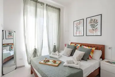 a bedroom with a bed with a tray of food on it at Long Bridge Apartment in Rome
