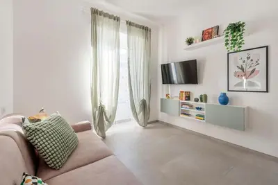 a living room with a couch and a television at Long Bridge Apartment in Rome