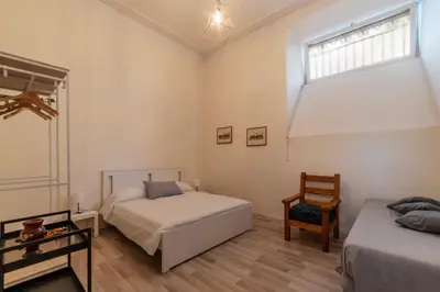a bedroom with two beds and a window at GuestHost - Piazza Nievo a Trastevere Cozy Apartment in Rome