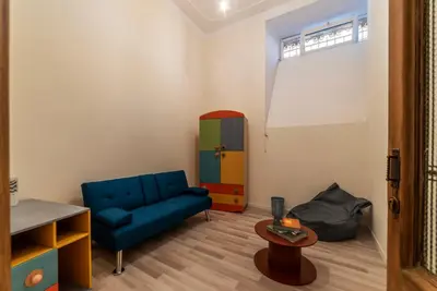 a living room with a blue couch and a table at GuestHost - Piazza Nievo a Trastevere Cozy Apartment in Rome