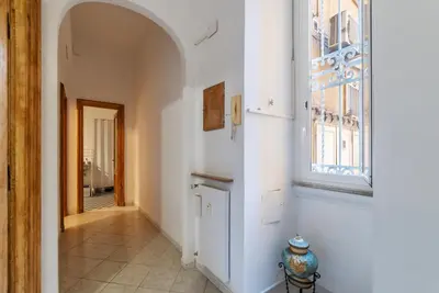 a hallway with a window and a fire hydrant at GuestHost - Piazza Nievo a Trastevere Cozy Apartment in Rome