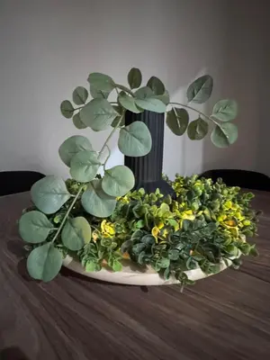a vase with a plant on top of a table at Roman Location San Pietro in Rome
