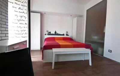 a bedroom with a bed with a colorful blanket at St Peter apartment - Sister's Place in Rome