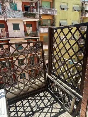 a balcony with a wooden gate and a building at St Peter apartment - Sister's Place in Rome