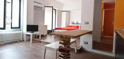 a room with a bed and a table with books at St Peter apartment - Sister's Place in Rome