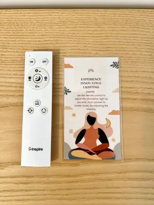 two brochures on a wooden table with a video game controller at Doria home-Saint Peter's View in Rome