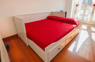 a bed in a room with a red mattress at Clodia Vatican House in Rome