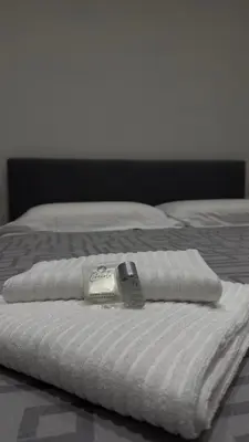 a white bed with a thermometer on top of it at Flora's Apartment in Rome