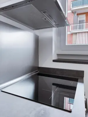 a kitchen with a stainless steel range hood at Flora's Apartment in Rome