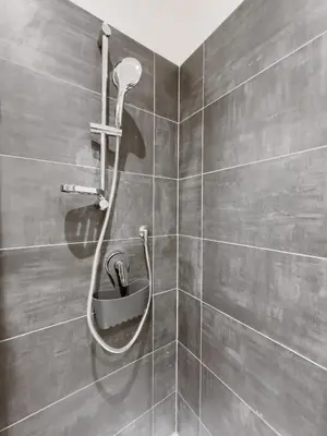 a bathroom with a shower with a faucet at Flora's Apartment in Rome