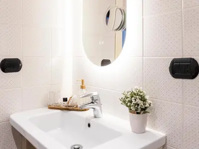 a white bathroom with a sink and a mirror at JB Relais- Campo de' Fiori in Rome