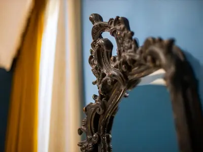 a close up of a mirror in front at JB Relais- Campo de' Fiori in Rome