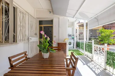 a wooden table with a potted plant on a balcony at Casa Gemelli - Metro per il centro di Roma - in Rome