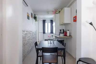 a dining room with a table and chairs in a kitchen at Casa Gemelli - Metro per il centro di Roma - in Rome