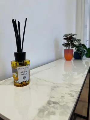 a table with a jar with some plants on it at Vatican R(h)ome in Rome