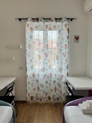 a room with a window with a curtain with hearts at Vatican R(h)ome in Rome
