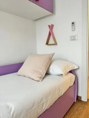a bed with a x sign on the wall at Vatican R(h)ome in Rome