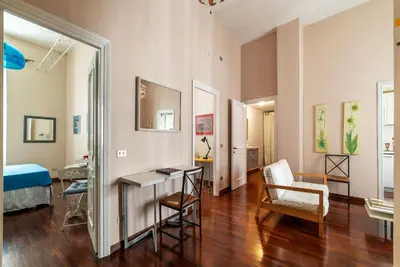 a living room with a table and a chair at Casa Farina - Pretty Homes in Rome