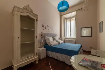a small bedroom with a bed and a table at Casa Farina - Pretty Homes in Rome