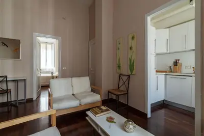 a living room with a white couch and a table at Casa Farina - Pretty Homes in Rome