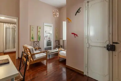 a living room with a table and chairs and a door at Casa Farina - Pretty Homes in Rome