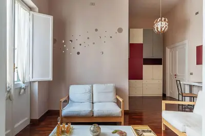 a living room with a blue chair and a table at Casa Farina - Pretty Homes in Rome