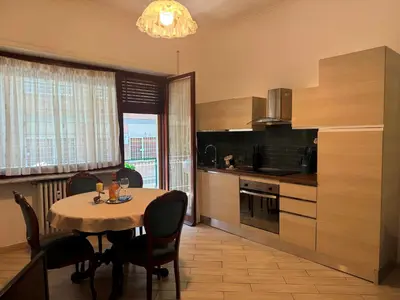 a kitchen with a table and chairs and a dining room at CASA LORY Balduina in Rome