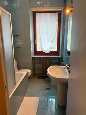 a bathroom with a sink and a toilet and a window at CASA LORY Balduina in Rome