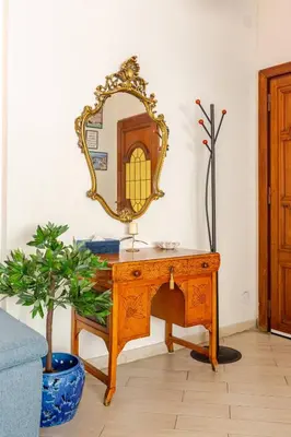 a dressing table with a mirror and a potted plant at CASA LORY Balduina in Rome