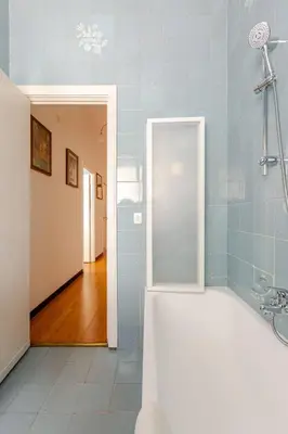 a bathroom with a bath tub and a mirror at CASA LORY Balduina in Rome