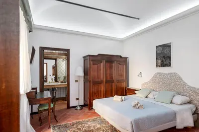 a bedroom with a bed and a desk in a room at Anima Beauty House in Rome