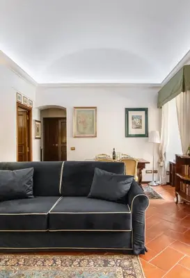 a living room with a black couch and a table at Anima Beauty House in Rome