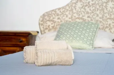 a pile of towels sitting on top of a bed at Anima Beauty House in Rome