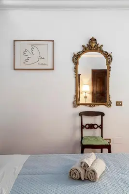 a bedroom with a bed with a mirror and a chair at Anima Beauty House in Rome