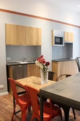 a kitchen with a table with a vase of flowers on it at Roma Capoccia in Vaticano in Rome