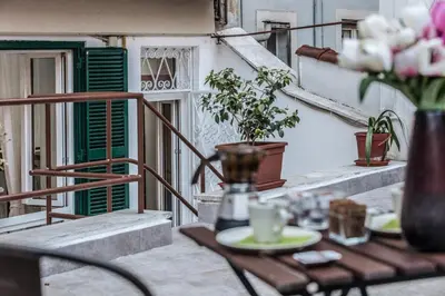 a table and chairs on a balcony with flowers at Roma Capoccia in Vaticano in Rome