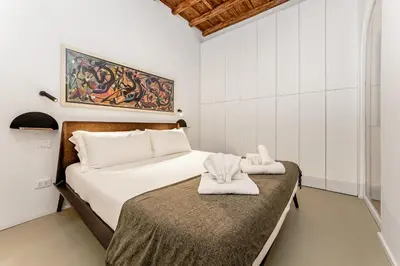 a bedroom with a bed with towels on it at 4BNB - Luxury Navona Apartment in Rome