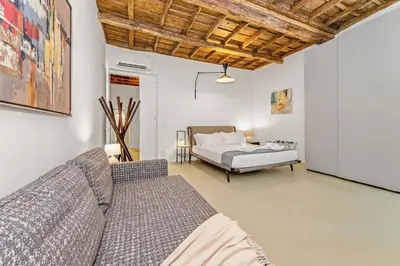 a living room with a couch and a bed at 4BNB - Luxury Navona Apartment in Rome