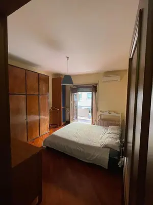 a bedroom with a bed and a large window at Gaio Melisso Home in Rome