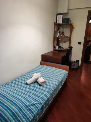 a bedroom with a bed with two towels on it at Gaio Melisso Home in Rome